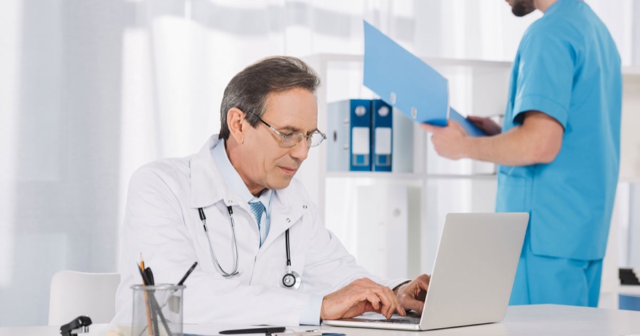 Physician working at a laptop